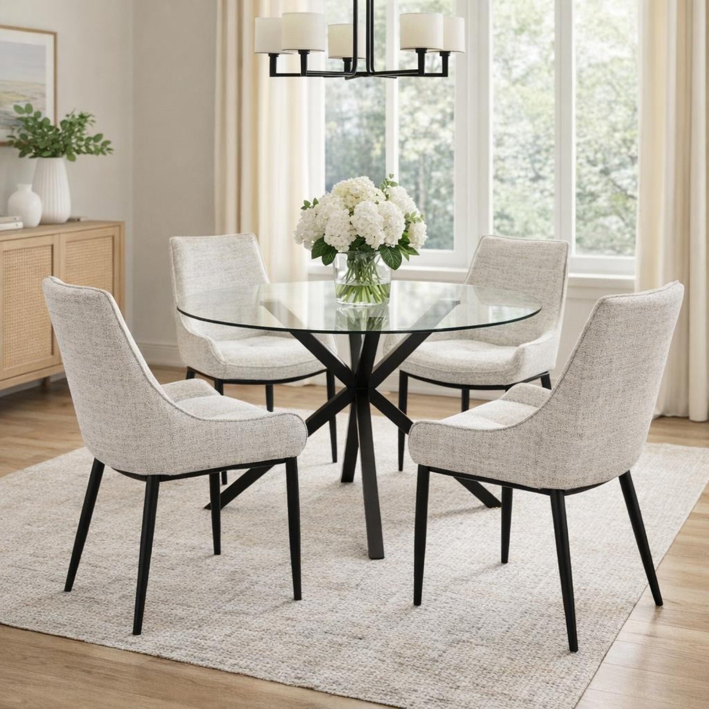 Round dining table by Dine and Dwell with a glass top and black metal legs, perfect for modern dining spaces.