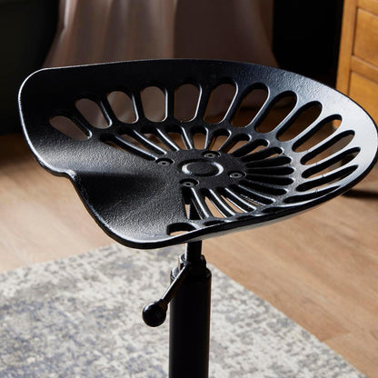 Black metal Dine and Dwell Norwich adjustable tractor bar stool with wooden seat and metal frame, modern and stylish for kitchen or bar area.