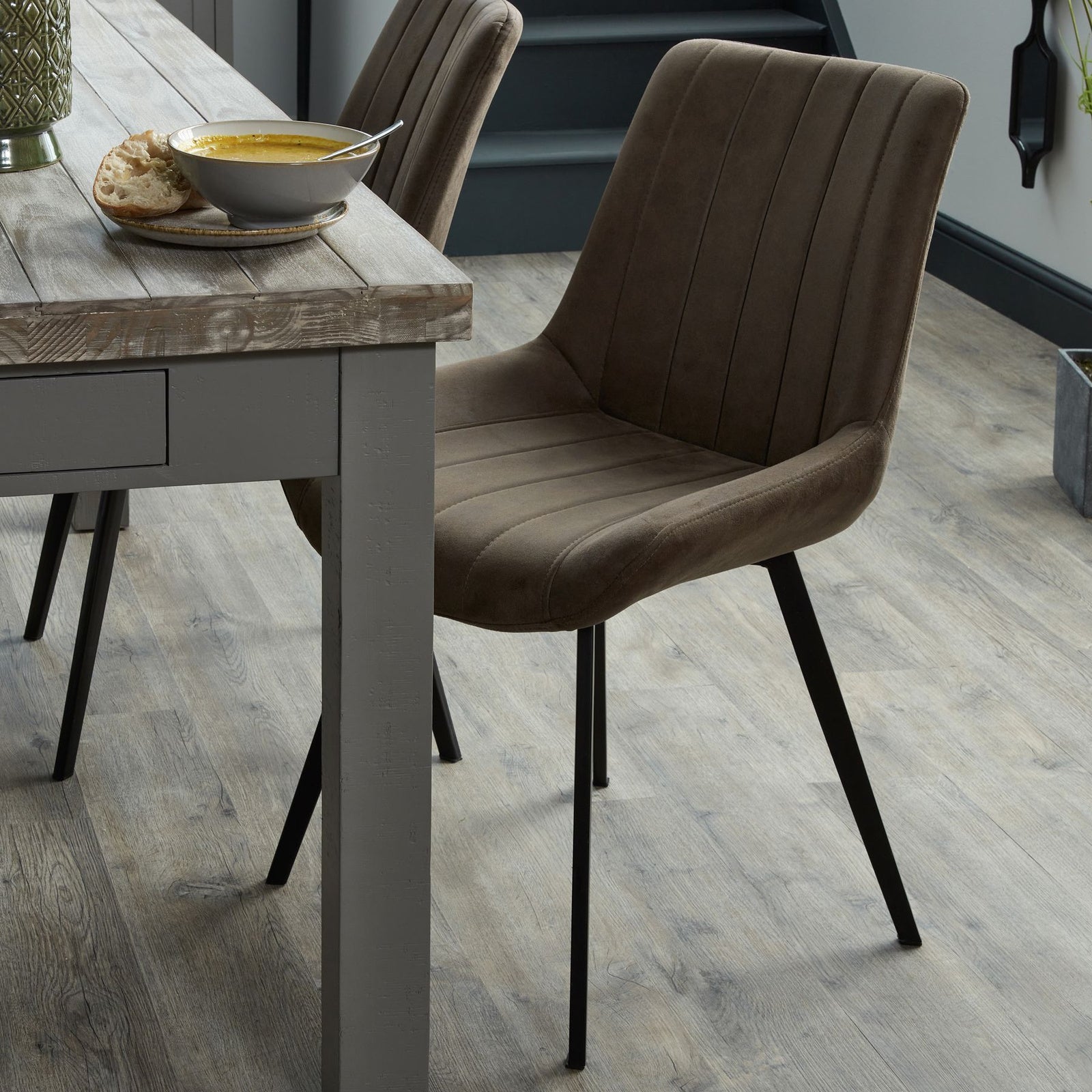 Wareham leather-effect fabric dining chair with channel stitching and black metal legs by Dine and Dwell.