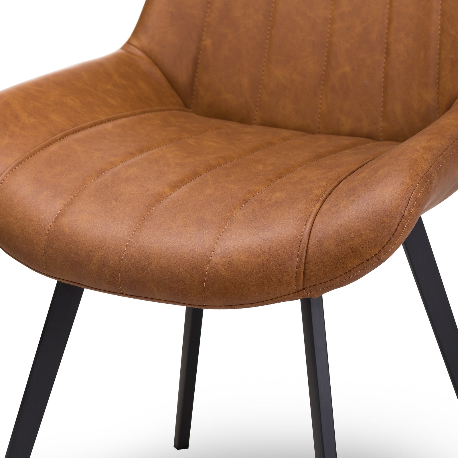 Tan Wareham dining chair by Dine and Dwell with faux leather upholstery, channel stitching, and black metal legs.