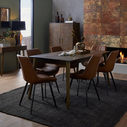 Wareham Tan dining chair by Dine and Dwell with faux leather upholstery, channel stitching, and black metal legs.