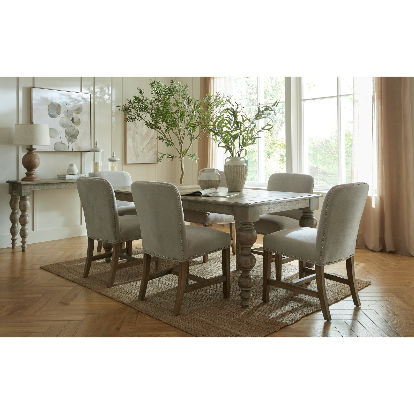 Winchester grey upholstered dining chair with oak frame and brass studding, designed for stylish dining rooms by Dine and Dwell.