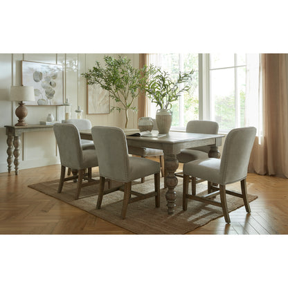 Winchester grey upholstered dining chair with oak frame and brass studding, designed for stylish dining rooms by Dine and Dwell.