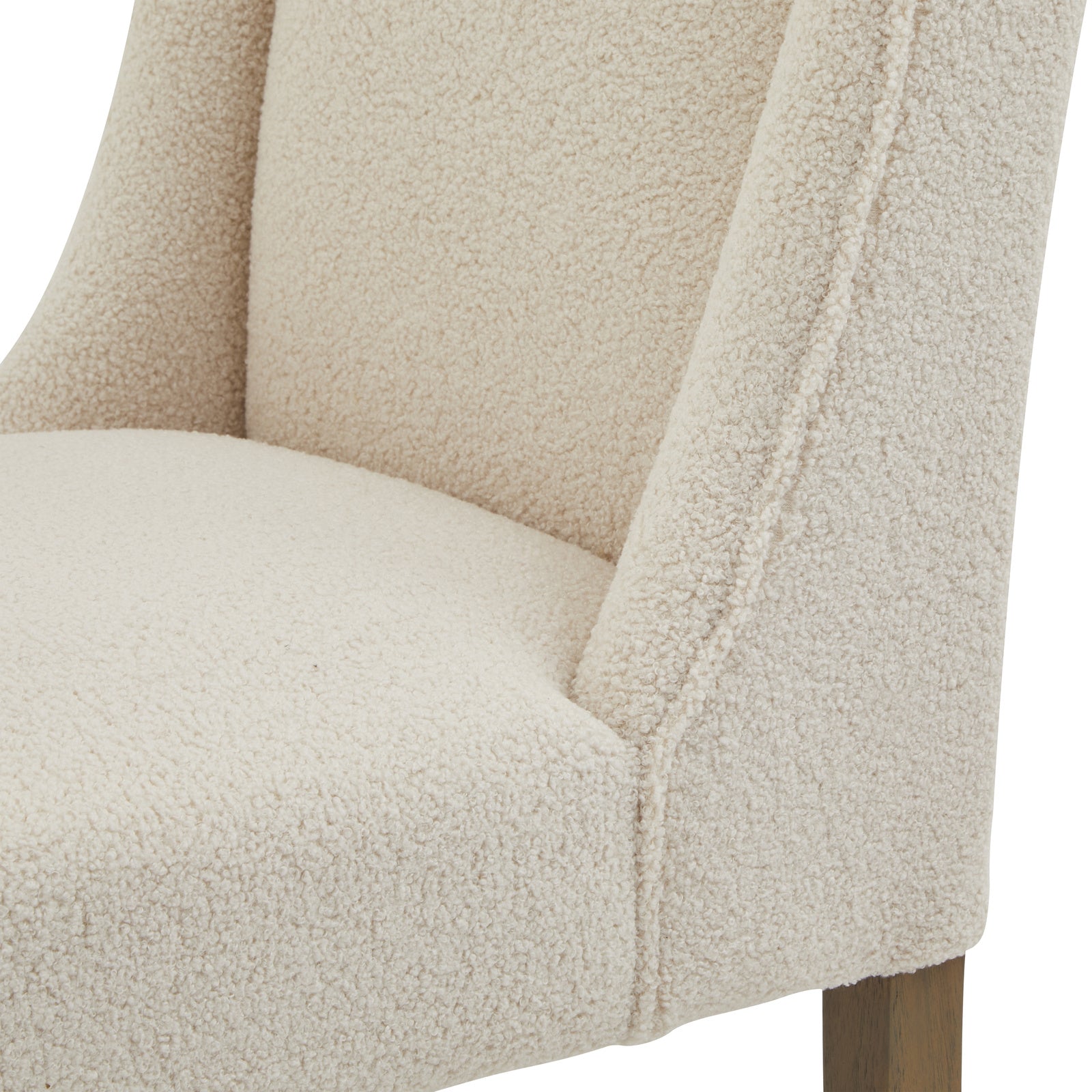 Cream upholstered Dine and Dwell Bristol Boucle dining chair with wooden legs, featuring a plush fabric seat and modern design.