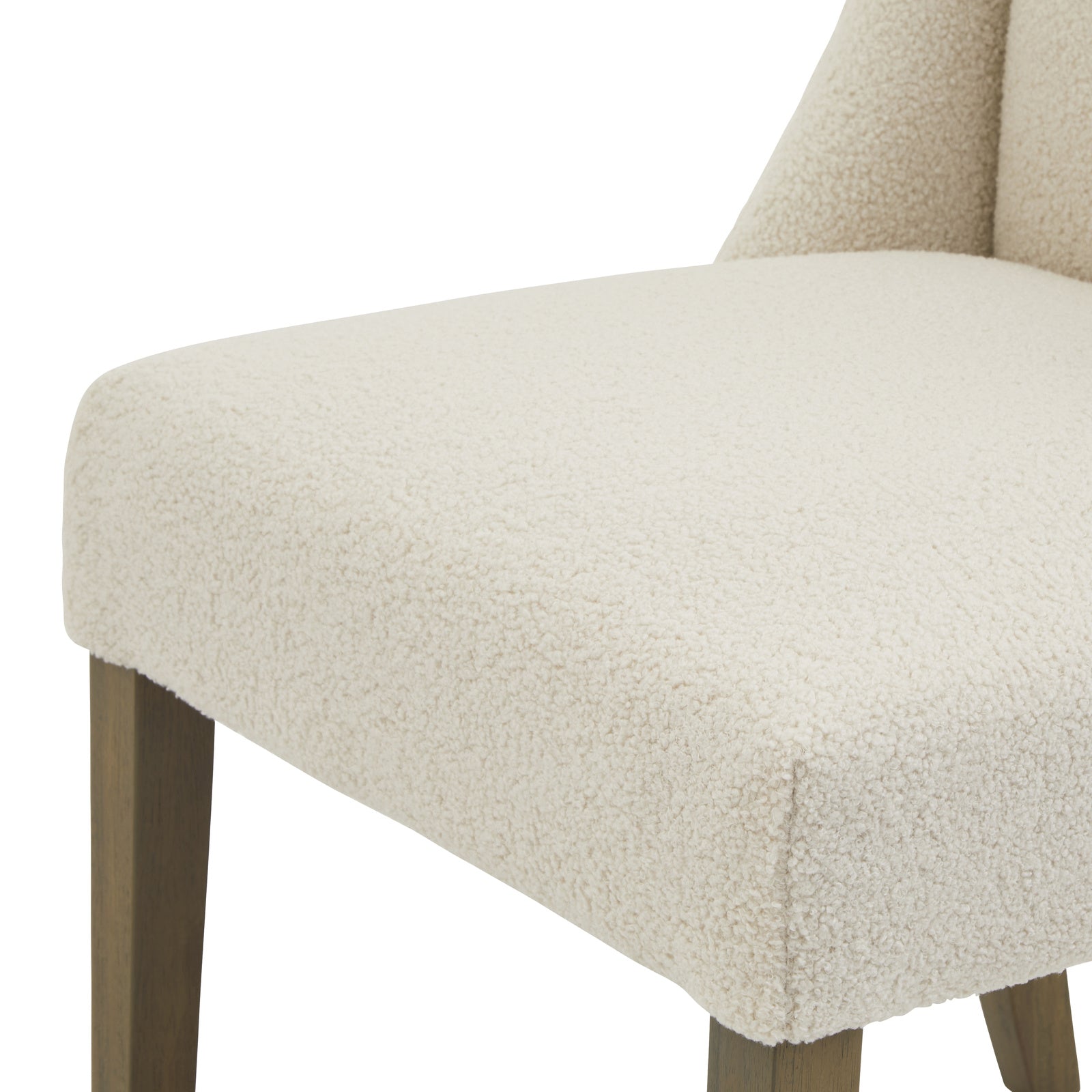 Cream upholstered Dine and Dwell Bristol Boucle dining chair with wooden legs, showcasing plush fabric and modern design.