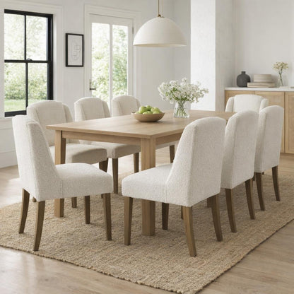 Cream upholstered Dine and Dwell Bristol Boucle Dining Chair with wooden legs, featuring a plush fabric and contemporary design.