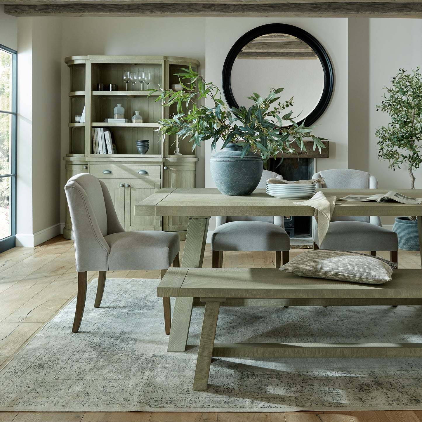 Grey upholstered Dine and Dwell Bristol dining chair with wooden legs, showcasing a comfortable and stylish dining room seat.