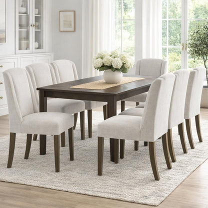 Grey upholstered Dine and Dwell Bristol dining chair with wooden legs, showcasing a modern, comfortable design.