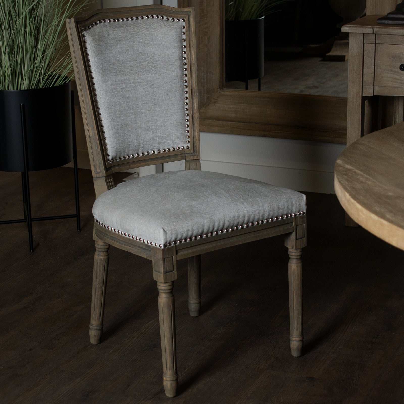 Grey upholstered Dine and Dwell Cambridge dining chair with wooden legs, showcasing a modern and comfortable design.