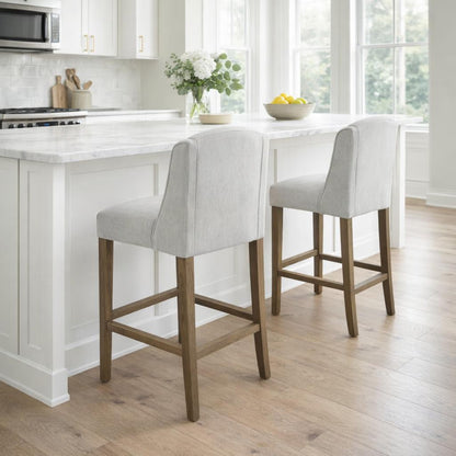 Grey upholstered fabric Dine and Dwell Bristol bar stool with wooden legs, modern design, and comfortable seat.