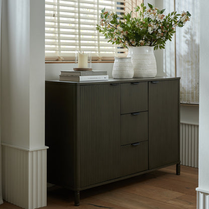 Brown wood Dine and Dwell Shrewsbury cabinet with 3 drawers and 2 doors, showcasing a stylish storage solution.