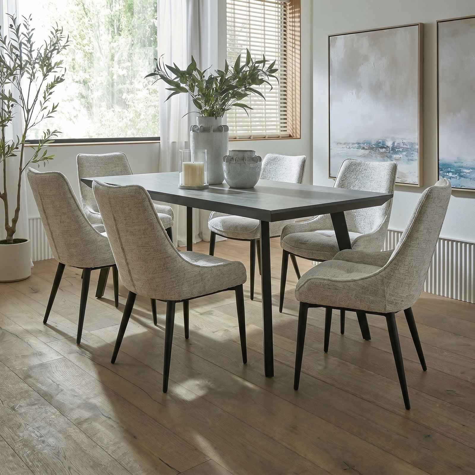Upholstered Worcester dining armchair in oatmeal fabric with black metal legs, modern dining chair by Dine and Dwell.