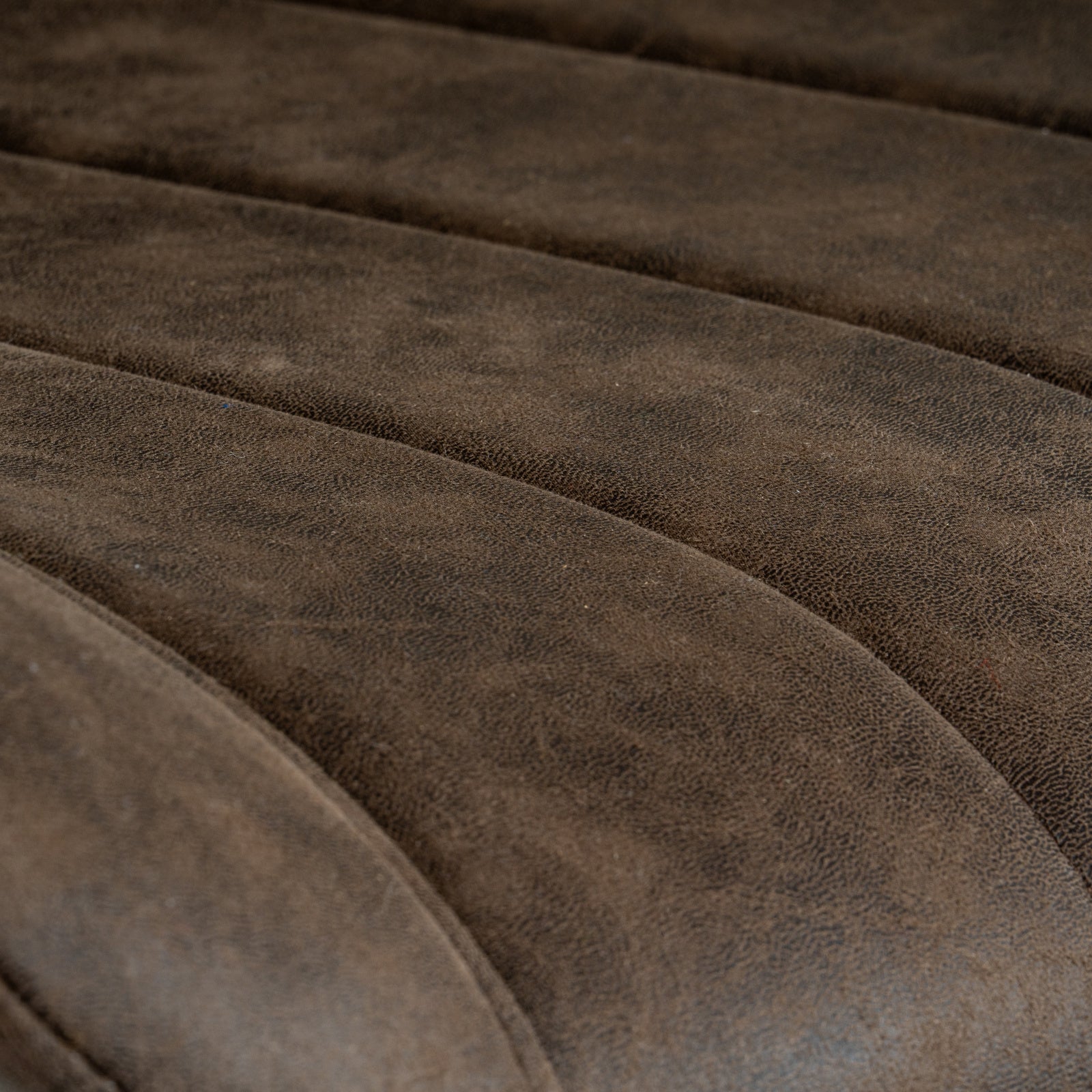 Wareham coffee swivel dining chair by Dine and Dwell with leather-effect fabric, channel stitching, and black metal base.