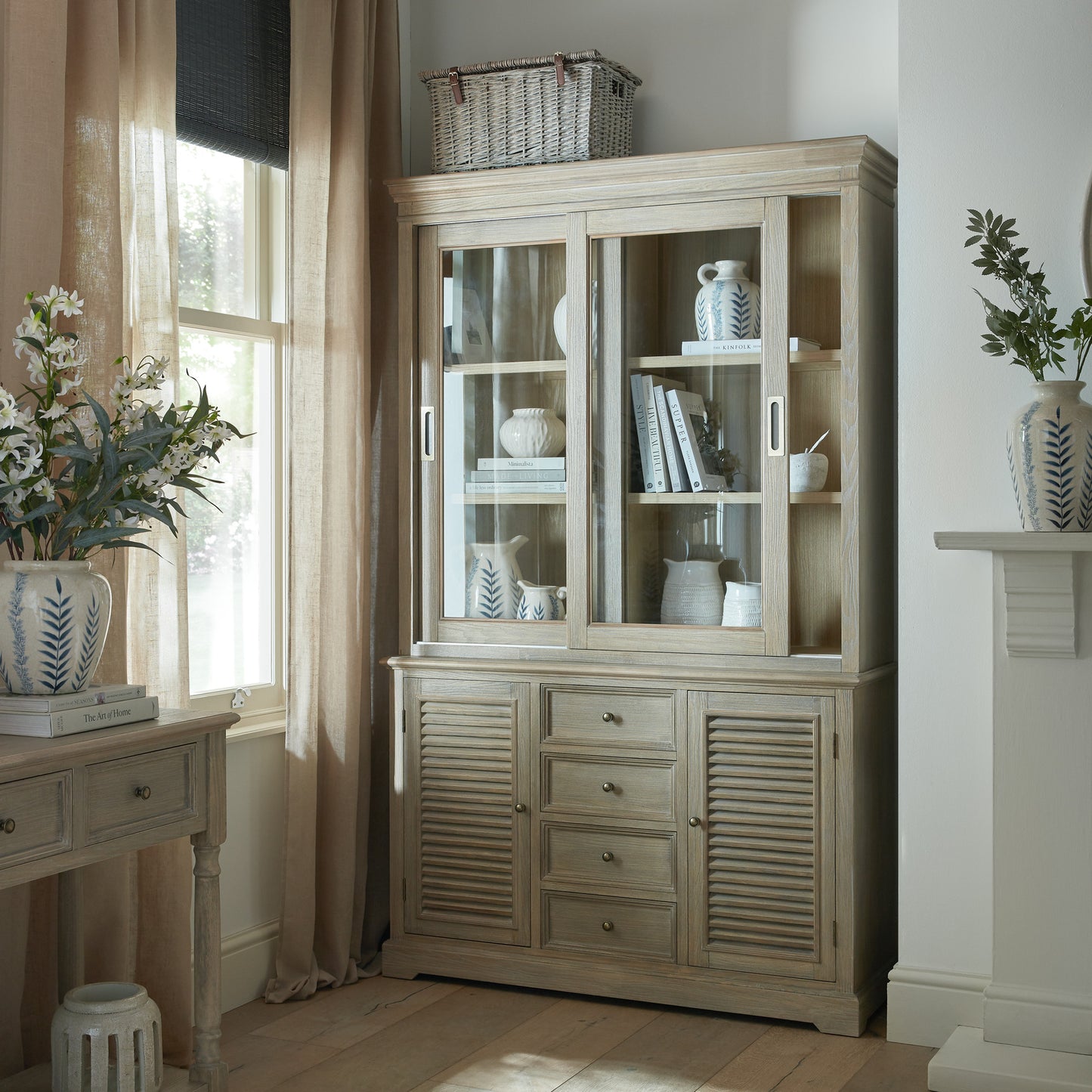 Dine and Dwell Leamington sliding glass dresser top cabinet with brown wood frame and clear glass doors.
