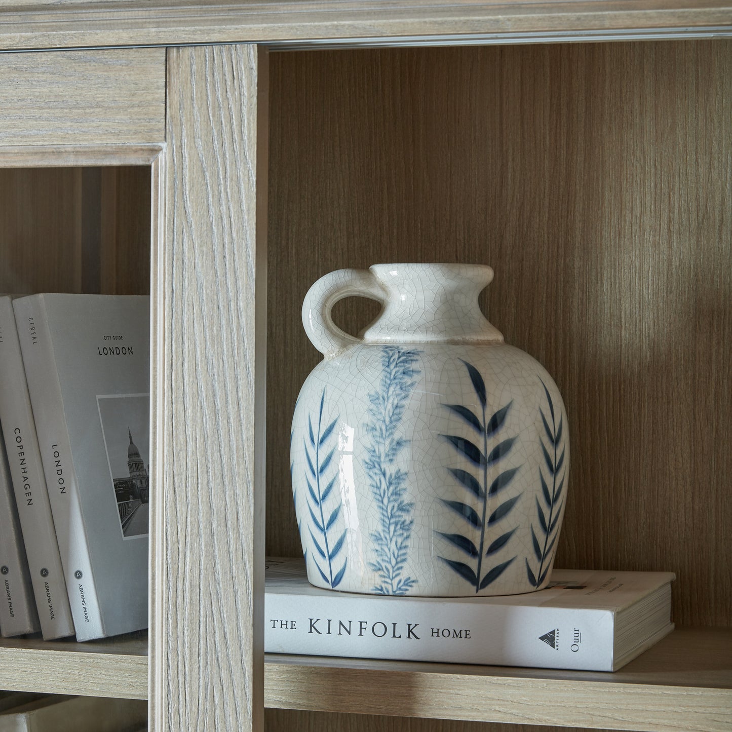 Brown wood and glass Dine and Dwell Leamington sliding glass dresser top cabinet with sleek design and modern style.