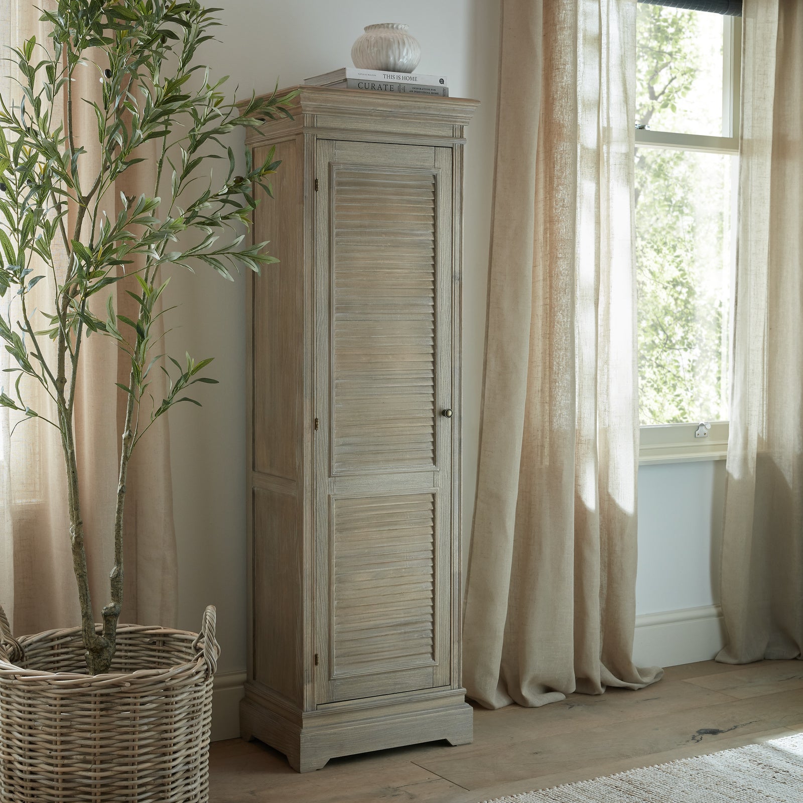 Dine and Dwell Leamington brown wood tall cabinet with one door, sleek storage solution for living or dining rooms.