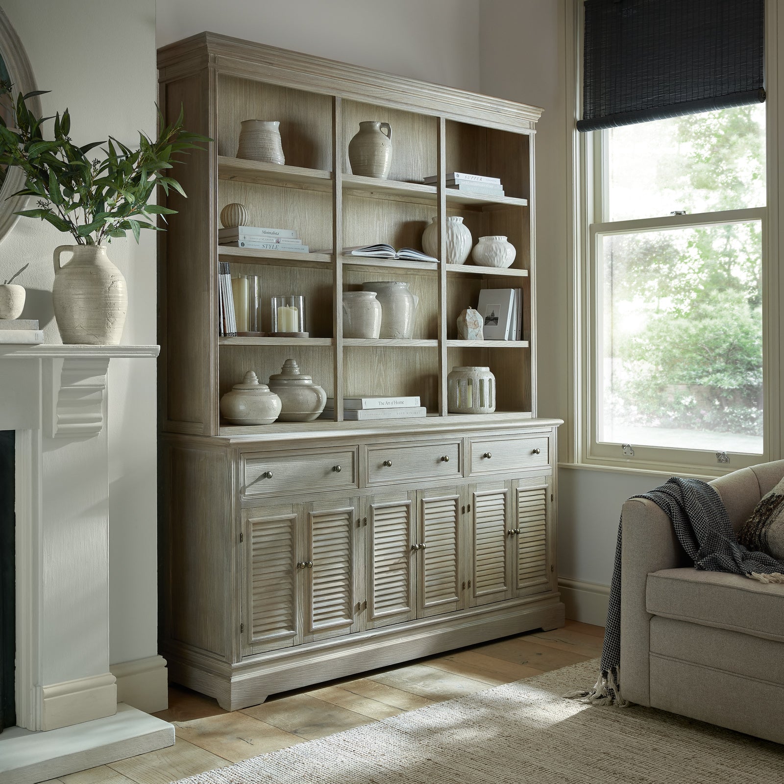 Dine and Dwell Leamington large brown wood sideboard with three shelves, serving as a stylish dresser top or storage unit.