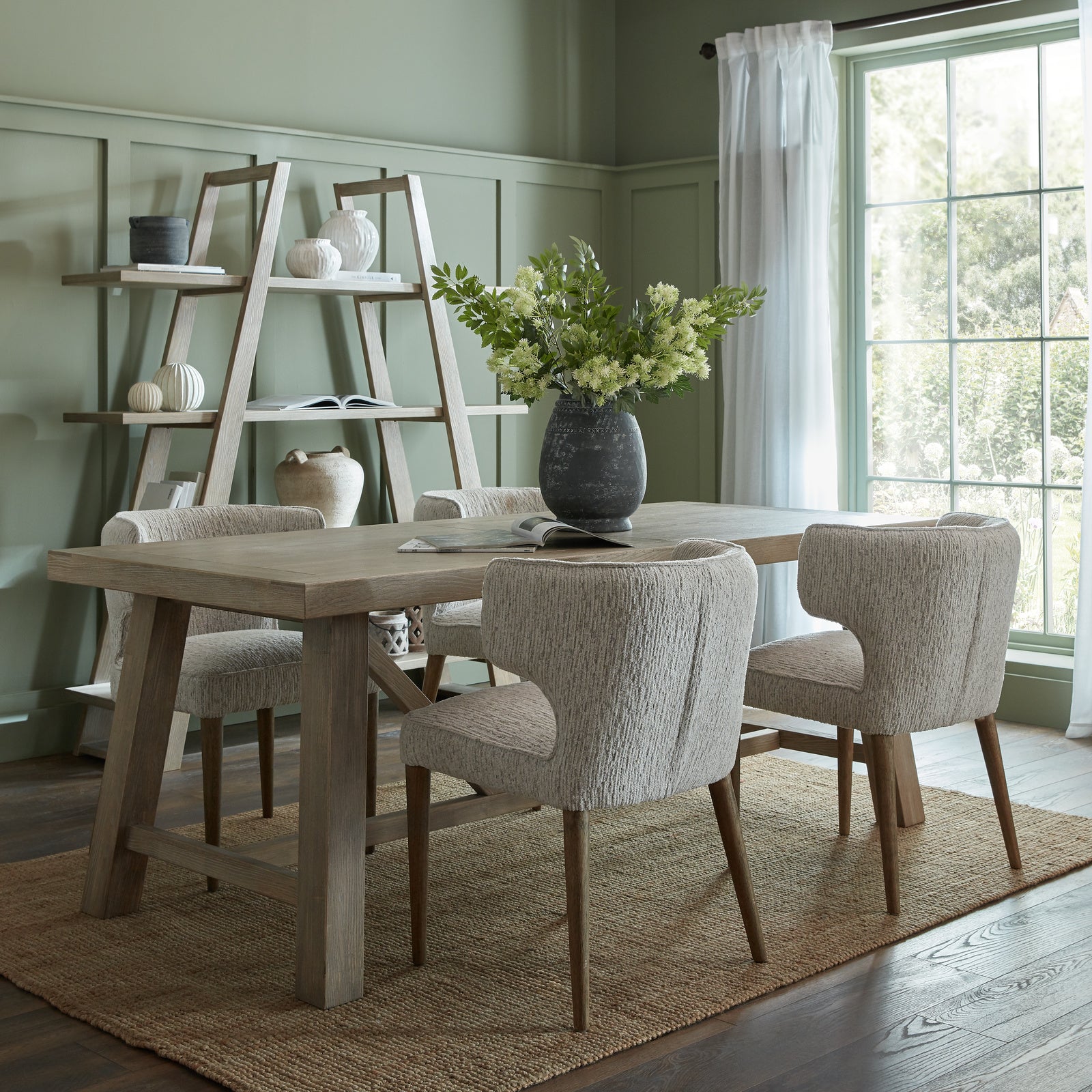 Large Dine and Dwell Tunbridge dining table in a spacious dining room, showcasing its wooden surface and sturdy legs.